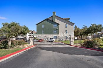 The view of a house with a gate and a driveway